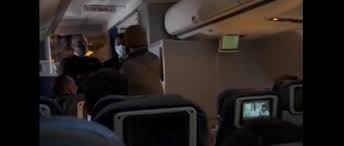 US man accused of stabbing flight attendant, trying to open exit door