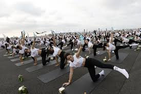‘Feel like a beautiful bird’: hundreds do yoga on Thai airport runway